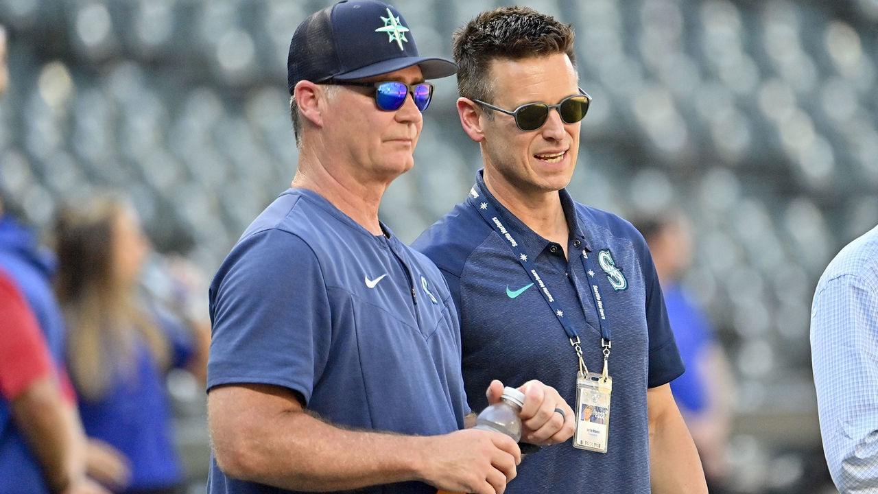 SEATTLE, WASHINGTON - JULY 26: Manager Scott Servais #9 and Baseball Operations President Jerry Dipoto of the Seattle Mariners watch batting practice before the game against the Texas Rangers at T-Mobile Park on July 26, 2022 in Seattle, Washington.
