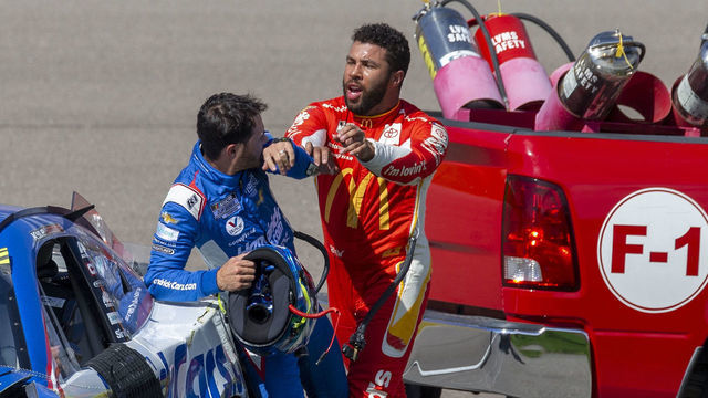 LAS VEGAS, NV - OCTOBER 16: Bubba Wallace (#45 23XI Racing MoneyLion Toyota) shoves Kyle Larson (#5 Hendrick Motorsports HendrickCars.com Chevrolet) after they wrecked in the tri-oval before turn 1 during the NASCAR Cup Series Playoff South Point 400 on October 16, 2022, at Las Vegas Motor Speedway in Las Vegas, NV.