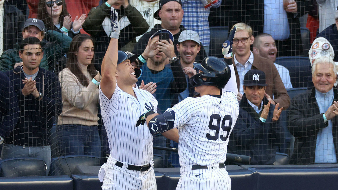 NEW YORK, NEW YORK - OCTOBER 18: Giancarlo Stanton #27 of the New York Yankees congratulates Aaron Judge #99 after his home run against the Cleveland Guardians during the second inning in game five of the American League Division Series at Yankee Stadium on October 18, 2022 in New York, New York.