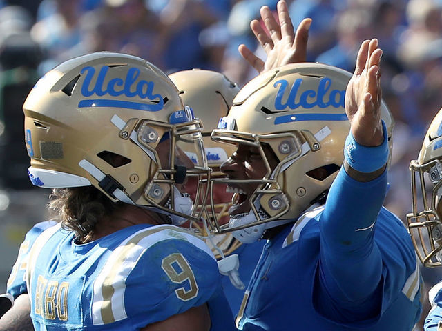 PASADENA, CALIF. - OPC T. 8, 2022. UCLA wide receiver Jake Bobo (7) and quarterback Dorian Thompson-Robinson (1) celebrate after hooking up on a touchdown pass play against Utah in the third quarter Saturday, Oct. 8, 2022, at the Rose Bowl in Pasadena. (Luis Sinco / Los Angeles Times via Getty Images)