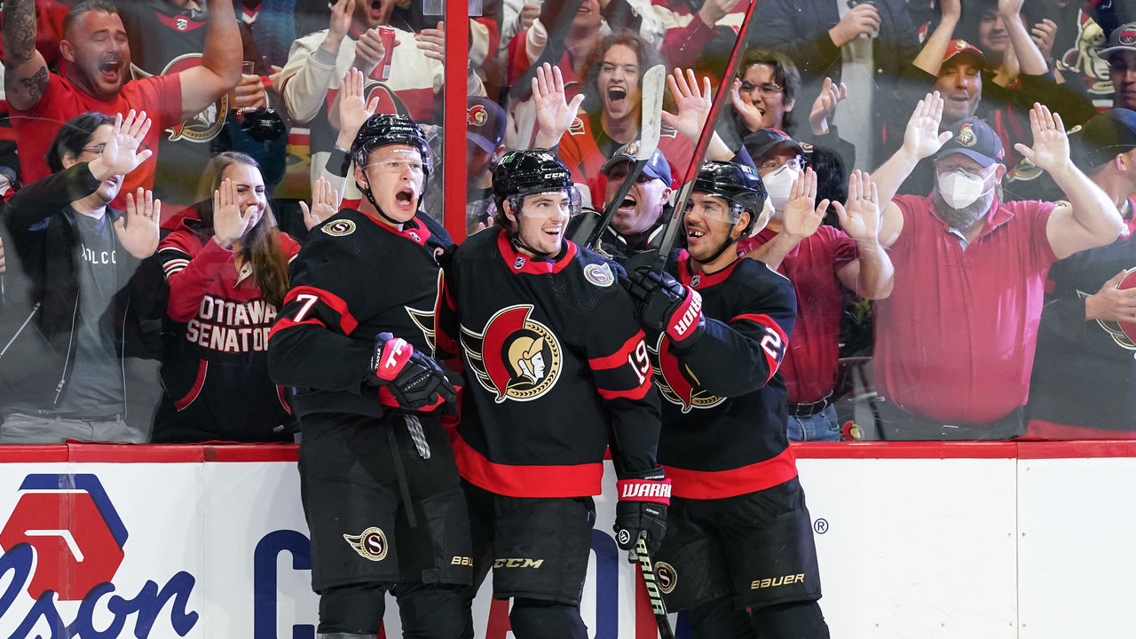 OTTAWA, CANADA - OCTOBER 18: Brady Tkachuk #7 of the Ottawa Senators celebrates his second period goal with teammates Drake Batherson #19 and Travis Hamonic #23 against the Boston Bruins at Canadian Tire Centre on October 18, 2022 in Ottawa, Ontario, Canada.