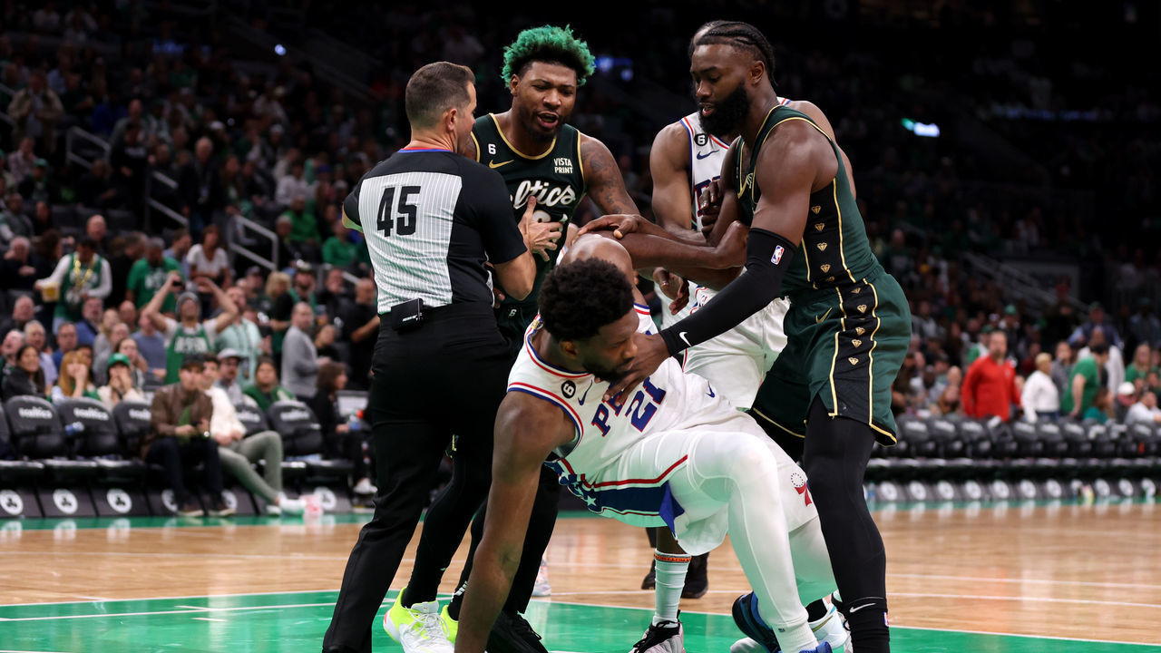 BOSTON, MASSACHUSETTS - OCTOBER 18: Marcus Smart #36 of the Boston Celtics and Joel Embiid #21 of the Philadelphia 76ers are separated by referee Brian Forte #45 during the second half at TD Garden on October 18, 2022 in Boston, Massachusetts.