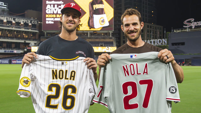 SAN DIEGO, CA - AUGUST 21: Austin Nola #26 of the San Diego Padres swaps jerseys with his brother Aaron Nola #27 of the Philadelphia Phillies on August 21, 2021 at Petco Park in San Diego, California.