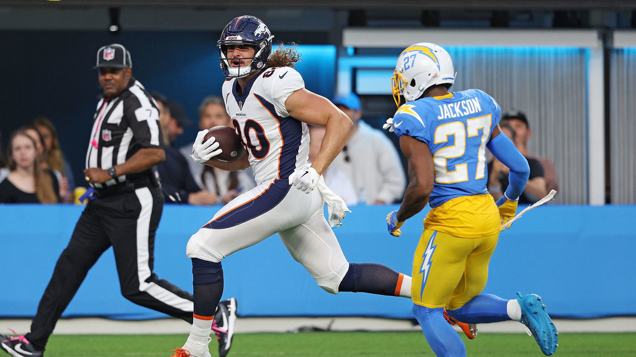 INGLEWOOD, CALIFORNIA - OCTOBER 17: Greg Dulcich #80 of the Denver Broncos scores a touchdown in front of J.C. Jackson #27 of the Los Angeles Chargers during the first quarter at SoFi Stadium on October 17, 2022 in Inglewood, California.