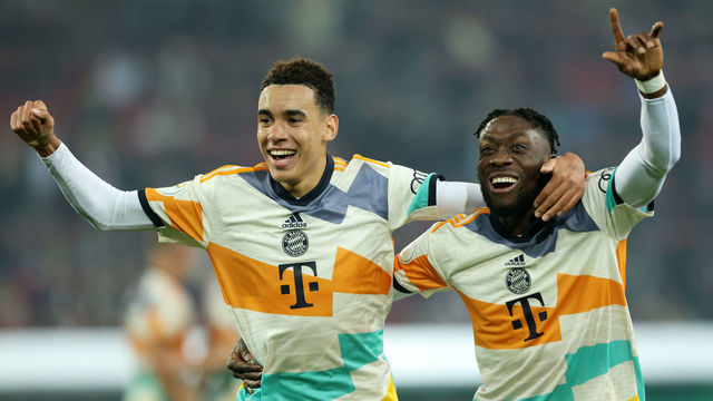 AUGSBURG, GERMANY - OCTOBER 19: Jamal Musiala of Bayern Munich celebrates scoring their side's fourth goal with teammate Alphonso Davies during the DFB Cup second round match between FC Augsburg and FC Bayern München at WWK-Arena on October 19, 2022 in Augsburg, Germany.