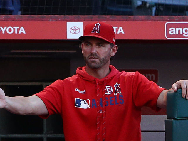 ANAHEIM, CALIFORNIA - AUGUST 14: Mike Trout #27 of the Los Angeles Angels is congratulated by hitting coach Jeremy Reed #77 as Trout enters the dugout after Trout scored in the fourth inning of the MLB game against the Pittsburgh Pirates at Angel Stadium of Anaheim on August 14, 2019 in Anaheim, California.