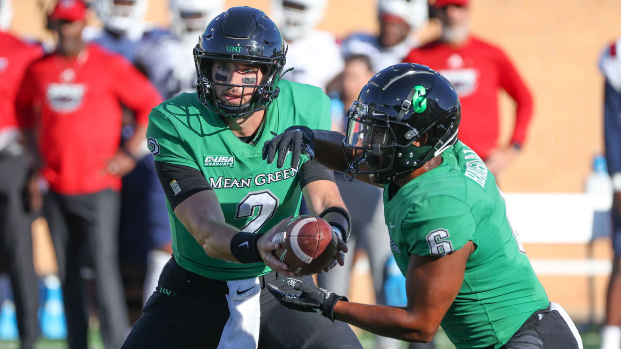 DENTON, TX - OCTOBER 01: North Texas Mean Green quarterback Austin Aune (2) hands off to North Texas Mean Green running back Ikaika Ragsdale (6) during the game between Florida Atlantic and North Texas on October 1, 2022 at Apogee Stadium in Denton, TX.