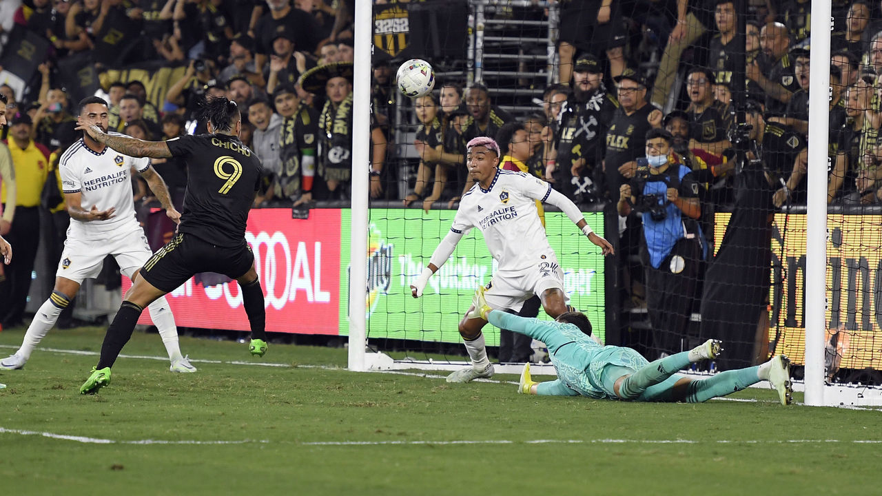 LOS ANGELES, CA - OCTOBER 20: Cristian Arango #9 of Los Angeles FC scores the winning goal against goalkeeper Jonathan Bond #1 and defender Julian Araujo #2 of Los Angeles Galaxy during the second half of the Western Conference Semifinals of 2022 MLS Cup playoffs at Banc of California Stadium on October 20, 2022 in Los Angeles, California.