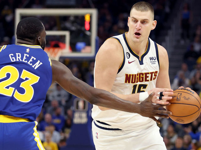 SAN FRANCISCO, CALIFORNIA - OCTOBER 21: Nikola Jokic #15 of the Denver Nuggets is guarded by Draymond Green #23 of the Golden State Warriors at Chase Center on October 21, 2022 in San Francisco, California.