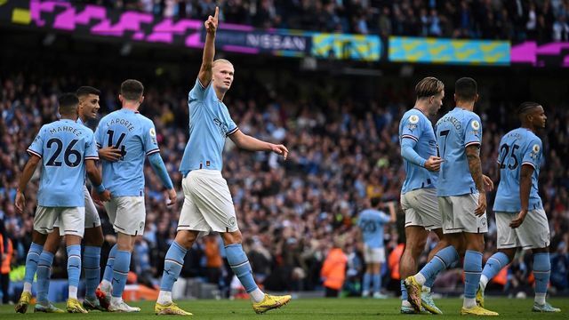 Manchester City's Norwegian striker Erling Haaland (C) celebrates scoring the opening goal during the English Premier League football match between Manchester City and Brighton and Hove Albion at the Etihad Stadium in Manchester, north west England, on October 22, 2022. - RESTRICTED TO EDITORIAL USE. No use with unauthorized audio, video, data, fixture lists, club/league logos or 'live' services. Online in-match use limited to 120 images. An additional 40 images may be used in extra time. No video emulation. Social media in-match use limited to 120 images. An additional 40 images may be used in extra time. No use in betting publications, games or single club/league/player publications.