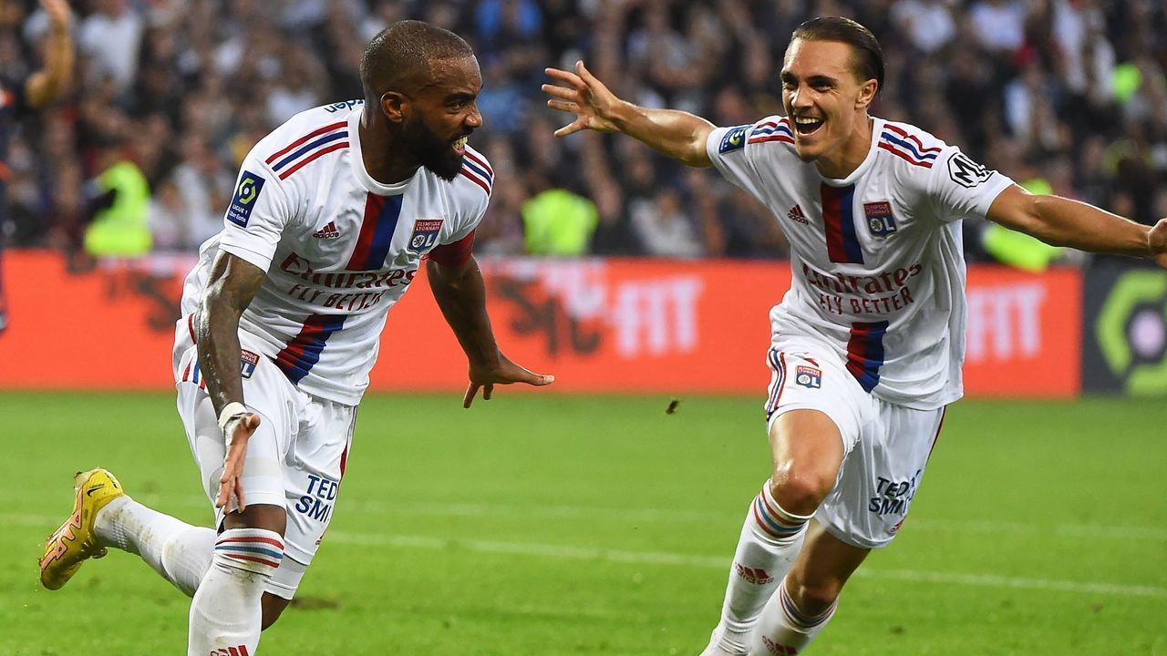 Lyon's French forward Alexandre Lacazette (L) celebrates after scoring a goal during the French L1 football match between Montpellier Herault SC and Olympique Lyonnais (OL) at The Stade de la Mosson in Montpellier, southern France on October 22, 2022.