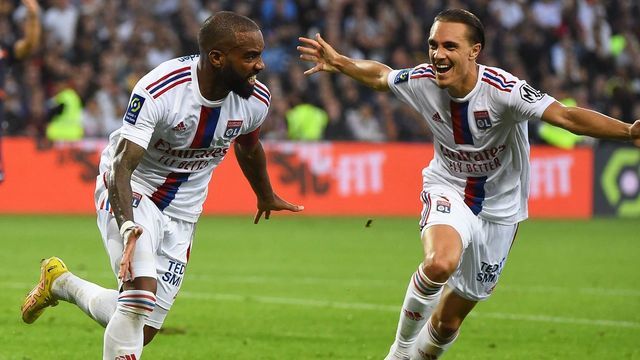 Lyon's French forward Alexandre Lacazette (L) celebrates after scoring a goal during the French L1 football match between Montpellier Herault SC and Olympique Lyonnais (OL) at The Stade de la Mosson in Montpellier, southern France on October 22, 2022.