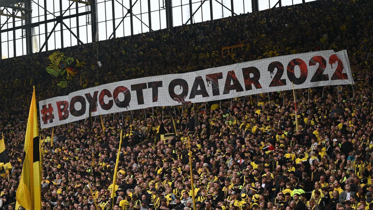Dortmund fans hold up a banner reading "#Boycott Qatar 2022" during the German first division Bundesliga football match between Borussia Dortmund and VfB Stuttgart in Dortmund, western Germany on October 22, 2022. - DFL REGULATIONS PROHIBIT ANY USE OF PHOTOGRAPHS AS IMAGE SEQUENCES AND/OR QUASI-VIDEO