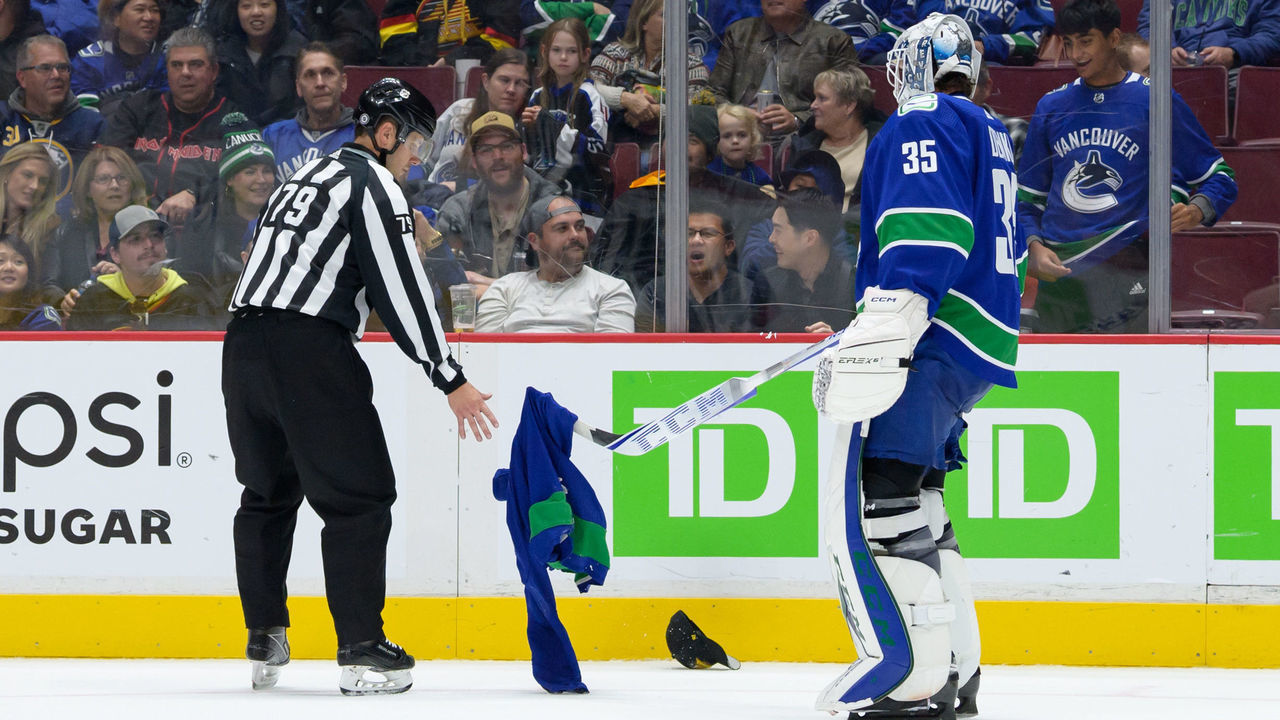 VANCOUVER, CANADA - OCTOBER 22: Thatcher Demko #35 of the Vancouver Canucks picks up a jersey that was thrown onto the ice by a fan in the third period during their NHL game against the Buffalo Sabres at Rogers Arena October 22, 2022 in Vancouver, British Columbia, Canada. Buffalo won 5-1.