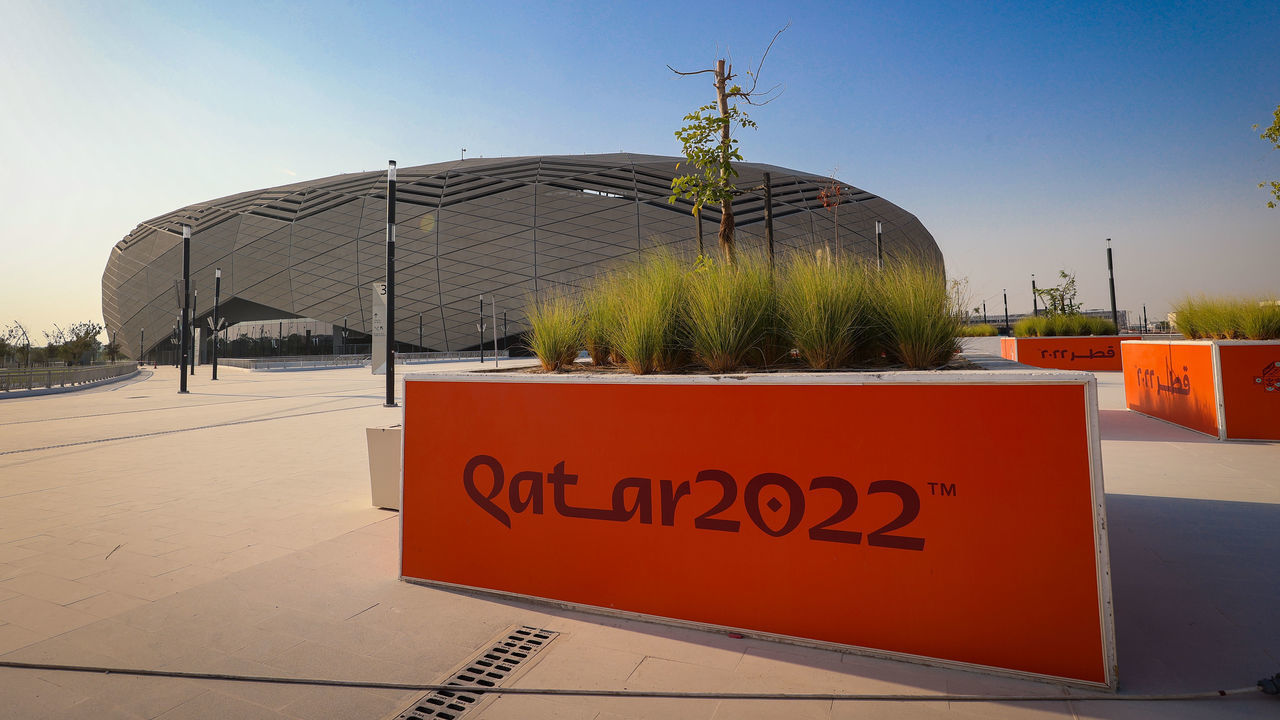DOHA, QATAR - OCTOBER 07: FIFA World Cup Qatar 2022 branding on the exterior of a general view of the Education City Stadium, a host venue for the Qatar 2022 FIFA World Cup. Education City Stadium has a design that draws on the rich history of Islamic architecture, blending it with striking modernity. The facade features triangles that form complex, diamond-esque geometrical patterns, appearing to change color with the sun's movement across the sky, on October 7, 2021 in Doha, Qatar.