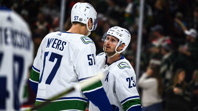 ST PAUL, MN - OCTOBER 20: Oliver Ekman-Larsson #23 of the Vancouver Canucks speaks with Tyler Myers #57 in the second period of the game against the Minnesota Wild at Xcel Energy Center on October 20, 2022 in St Paul, Minnesota.