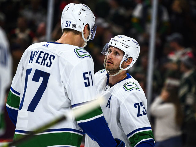 ST PAUL, MN - OCTOBER 20: Oliver Ekman-Larsson #23 of the Vancouver Canucks speaks with Tyler Myers #57 in the second period of the game against the Minnesota Wild at Xcel Energy Center on October 20, 2022 in St Paul, Minnesota.