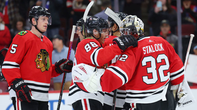CHICAGO, ILLINOIS - OCTOBER 25: Alex Stalock #32 of the Chicago Blackhawks celebrates with Patrick Kane #88 after defeating the Florida Panthers 3-2 at United Center on October 25, 2022 in Chicago, Illinois.