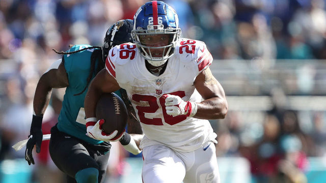 JACKSONVILLE, FLORIDA - OCTOBER 23: Saquon Barkley #26 of the New York Giants runs for yardage during the second half against the Jacksonville Jaguars at TIAA Bank Field on October 23, 2022 in Jacksonville, Florida.