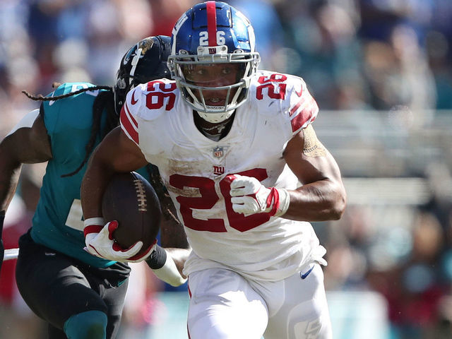 JACKSONVILLE, FLORIDA - OCTOBER 23: Saquon Barkley #26 of the New York Giants runs for yardage during the second half against the Jacksonville Jaguars at TIAA Bank Field on October 23, 2022 in Jacksonville, Florida.