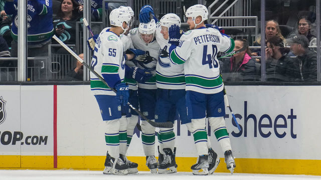 SEATTLE, WA - OCTOBER 27:Guillaume Brisebois #55, Luke Schenn #2, Ilya Mikheyev #65, Andrei Kuzmenko #96 and Elias Pettersson #40 of the Vancouver Canucks celebrate Mikheyevs goal against the Seattle Kraken during the first period of a game at Climate Pledge Arena on October 27, 2022 in Seattle, Washington.