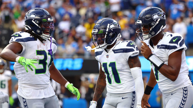 INGLEWOOD, CALIFORNIA - OCTOBER 23: DeeJay Dallas #31, Marquise Goodwin #11 and Geno Smith #7 of the Seattle Seahawks celebrate a touchdown during the second quarter against the Los Angeles Chargers at SoFi Stadium on October 23, 2022 in Inglewood, California. The Seattle Seahawks won 37-23.