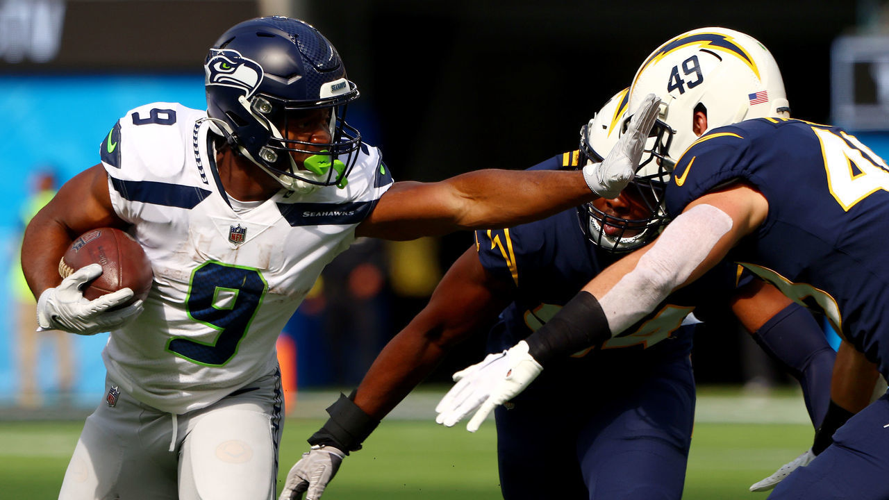 INGLEWOOD, CALIFORNIA - OCTOBER 23: Kenneth Walker III #9 of the Seattle Seahawks runs the ball against Drue Tranquill #49 of the Los Angeles Chargers during the first quarter at SoFi Stadium on October 23, 2022 in Inglewood, California. The Seattle Seahawks won 37-23.