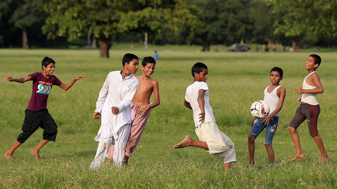 KOLKATA, INDIA - OCTOBER 05: General view of local children playing football ahead of the FIFA U-17 World Cup India 2017 tournament on October 5, 2017 in Kolkata, India.