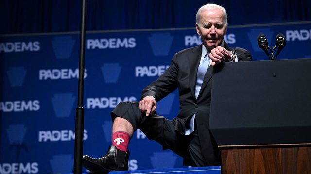 US President Joe Biden shows off his Philadelphia Phillies socks as he speaks at a reception for the Pennsylvania Democratic Party in Philadelphia on October 28, 2022.