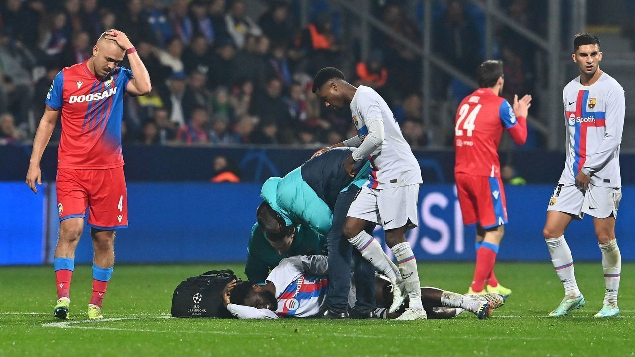 Barcelona's Ivorian midfielder Franck Kessie (bottom) receives medical treatment during the UEFA Champions League Group C football match FC Viktoria Plzen v FC Barcelona in Plzen, Czech Republic, on November 1, 2022.