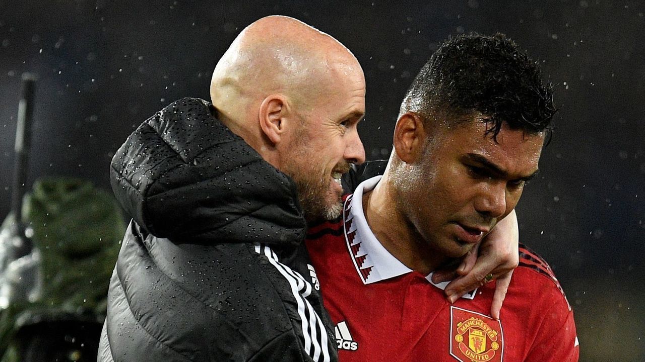 Manchester United's Dutch manager Erik ten Hag (L) and Manchester United's Brazilian midfielder Casemiro (R) after the final whistle of the English Premier League football match between Everton and Manchester United at Goodison Park in Liverpool, north west England on October 9, 2022. - RESTRICTED TO EDITORIAL USE. No use with unauthorized audio, video, data, fixture lists, club/league logos or 'live' services. Online in-match use limited to 120 images. An additional 40 images may be used in extra time. No video emulation. Social media in-match use limited to 120 images. An additional 40 images may be used in extra time. No use in betting publications, games or single club/league/player publications.
