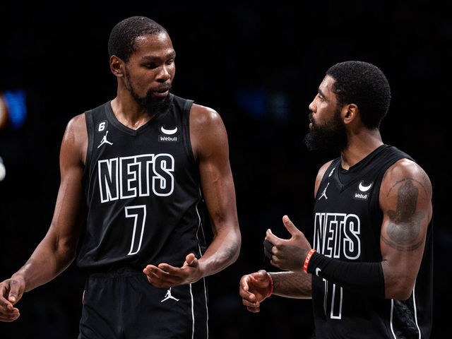 NEW YORK, NEW YORK - OCTOBER 31: Kevin Durant #7 speaks with Kyrie Irving #11 of the Brooklyn Nets during a break in the action during the fourth quarter of the game against the Indiana Pacers at Barclays Center on October 31, 2022 in New York City.