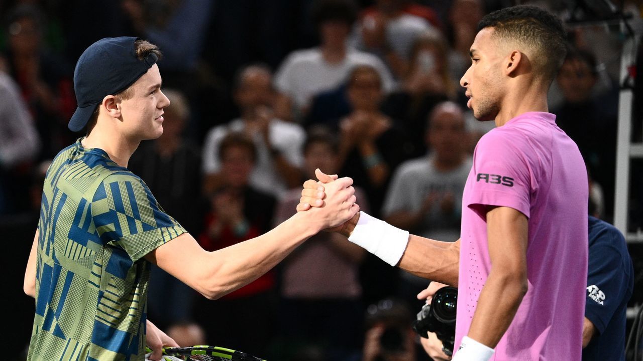 Denmark's Holger Rune (L) shakes hands with Canada's Felix Auger-Aliassime after winning at the end of their men's singles semi-final tennis match on day 6 of the ATP World Tour Masters 1000 - Paris Masters (Paris Bercy) - indoor tennis tournament at The AccorHotels Arena in Paris on November 5, 2022.