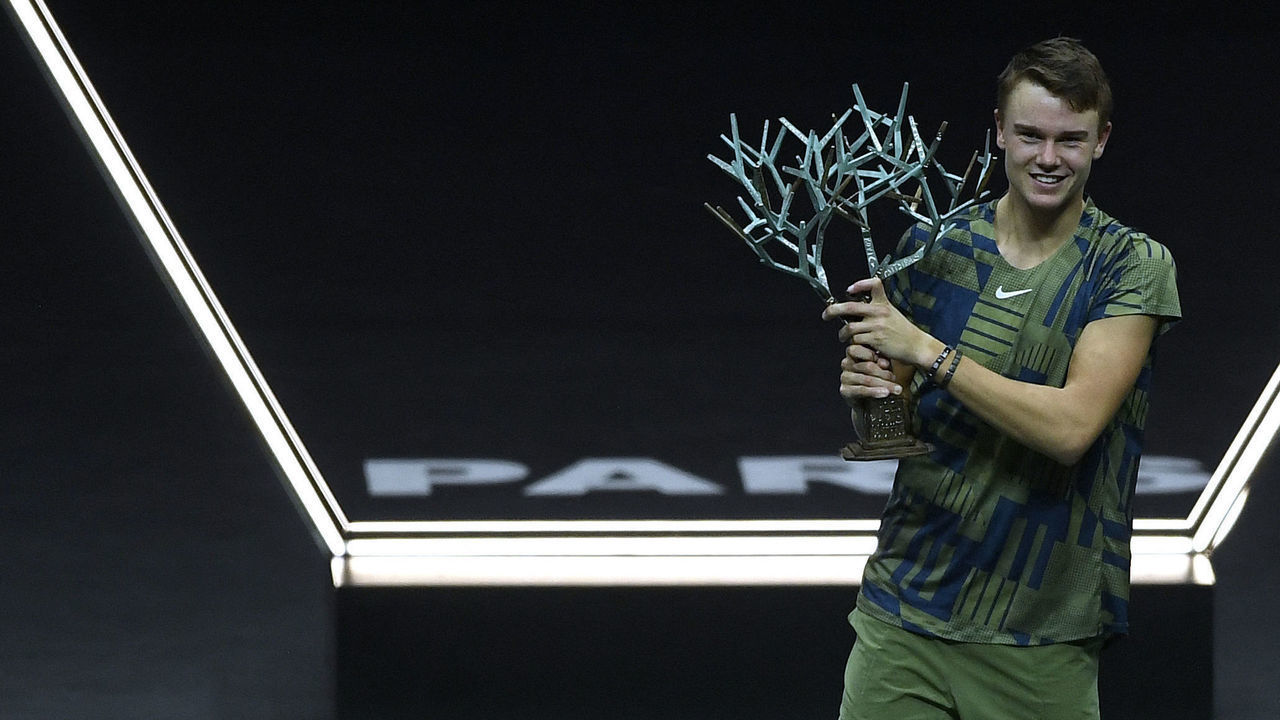 Denmark's Holger Rune celebrates with the trophy after winning his men's singles final tennis match against Serbia's Novak Djokovic, on day 7 of the ATP World Tour Masters 1000 - Paris Masters (Paris Bercy) - indoor tennis tournament at The AccorHotels Arena in Paris on November 6, 2022.