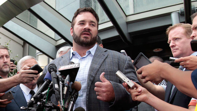 WASHINGTON, DC - JULY 25: DeMaurice Smith (L) executive director of the National Football League Players' Association and NFL commissioner Roger Goodell (R) look on as Indianapolis Colts center Jeff Saturday addresses the the media on July 25, 2011 in Washington, DC. The NFL players and owners announced they have reached agreement and ended the lockout.