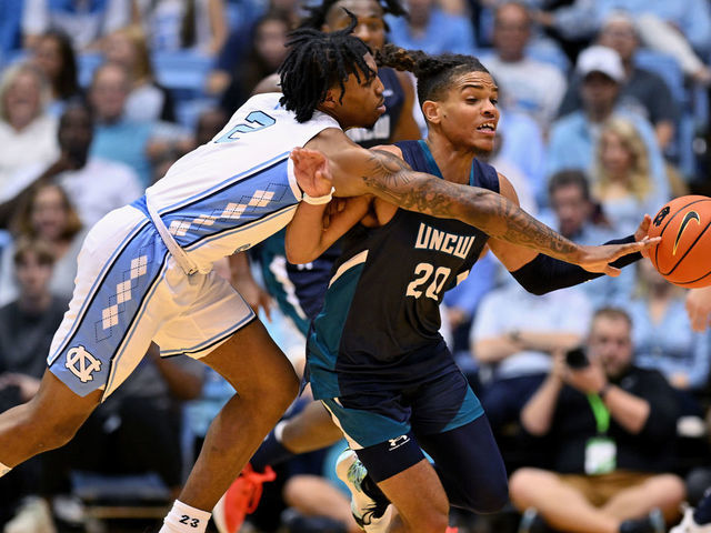 CHAPEL HILL, NORTH CAROLINA - NOVEMBER 07: Caleb Love #2 of the North Carolina Tar Heels knocks the ball away from Shykeim Phillips #20 of the North Carolina-Wilmington Seahawks during the first half of their game at the Dean E. Smith Center on November 07, 2022 in Chapel Hill, North Carolina.