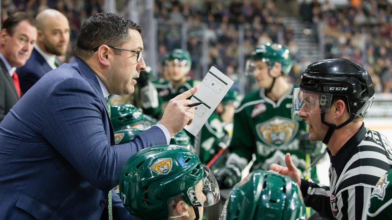 EVERETT, WA - DECEMBER 15: Everett Silvertips head coach Dennis Williams receives clarification on penalties from a referee in the first period during a game between the Seattle Thunderbirds and the Everett Silvertips on Saturday, December 15, 2018 at Angel of the Winds Arena in Everett, WA.