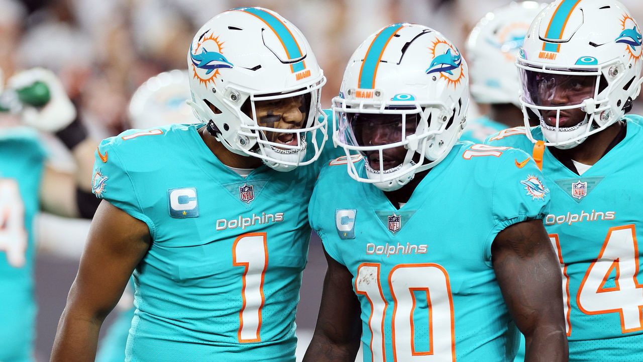 CINCINNATI, OHIO - SEPTEMBER 29: Quarterback Tua Tagovailoa #1 of the Miami Dolphins talks with wide receiver Tyreek Hill #10 after a play during the 1st half of the game against the Cincinnati Bengals at Paycor Stadium on September 29, 2022 in Cincinnati, Ohio.
