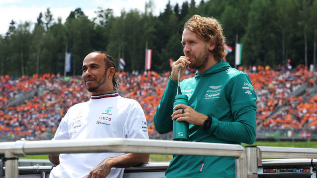 SPIELBERG, AUSTRIA - JULY 10: Lewis Hamilton of Great Britain and Mercedes and Sebastian Vettel of Germany and Aston Martin F1 Team look on from the drivers parade ahead of the F1 Grand Prix of Austria at Red Bull Ring on July 10, 2022 in Spielberg, Austria.