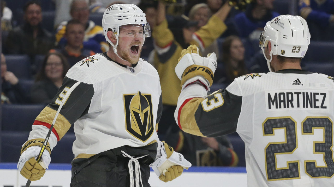 BUFFALO, NEW YORK - NOVEMBER 10: Jack Eichel #9 and Alec Martinez #23 of the Vegas Golden Knights celebrate after an empty-net goal by Eichel for a hat trick during the third period of an NHL hockey game at KeyBank Center on November 10, 2022 in Buffalo, New York.