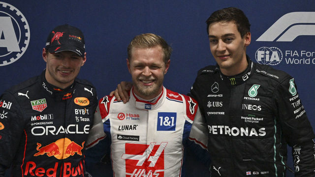 First-placed Haas F1 Team's Danish driver Kevin Magnussen (C) poses with second-placed Red Bull Racing's Dutch driver Max Verstappen (L) and third-placed Mercedes' British driver George Russell after the qualifying session at the Autodromo Jose Carlos Pace racetrack, also known as Interlagos, in Sao Paulo, Brazil, on November 11, 2022, ahead of the Formula One Brazil Grand Prix.