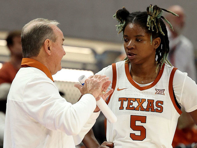 AUSTIN, TEXAS - OCTOBER 30: DeYona Gaston #5 of the Texas Longhorns listens to instructions from head coach Vic Schaefer during a charity exhibition game against the DePaul Blue Demons at the Moody Center on October 30, 2022 in Austin, Texas.