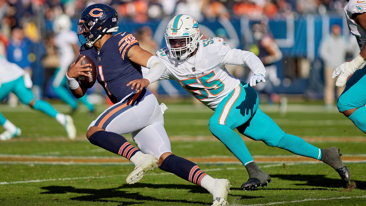 CHICAGO, IL - NOVEMBER 06: Chicago Bears quarterback Justin Fields (1) battles with Miami Dolphins linebacker Jerome Baker (55) in action during a game between the Chicago Bears and the Miami Dolphins on November 06, 2022, at Soldier Field in Chicago, IL.