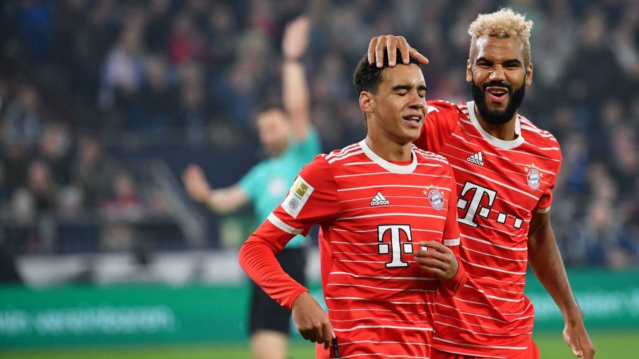 Bayern Munich's Cameroonian forward Eric Maxim Choupo-Moting (R) reacts with Bayern Munich's German midfielder Jamal Musiala during the German first division Bundesliga football match between Schalke 04 v Bayern Munich in Gelsenkirchen, western Germany, on November 12, 2022. - - DFL REGULATIONS PROHIBIT ANY USE OF PHOTOGRAPHS AS IMAGE SEQUENCES AND/OR QUASI-VIDEO