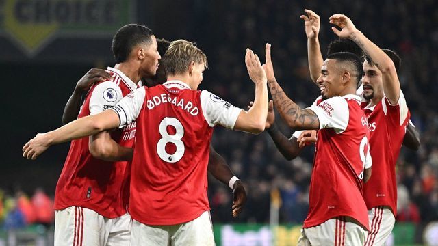Arsenal's Norwegian midfielder Martin Odegaard celebrates scoring his team's second goal with teammates during the English Premier League football match between Wolverhampton Wanderers and Arsenal at the Molineux stadium in Wolverhampton, central England on November 12, 2022. - RESTRICTED TO EDITORIAL USE. No use with unauthorized audio, video, data, fixture lists, club/league logos or 'live' services. Online in-match use limited to 120 images. An additional 40 images may be used in extra time. No video emulation. Social media in-match use limited to 120 images. An additional 40 images may be used in extra time. No use in betting publications, games or single club/league/player publications.