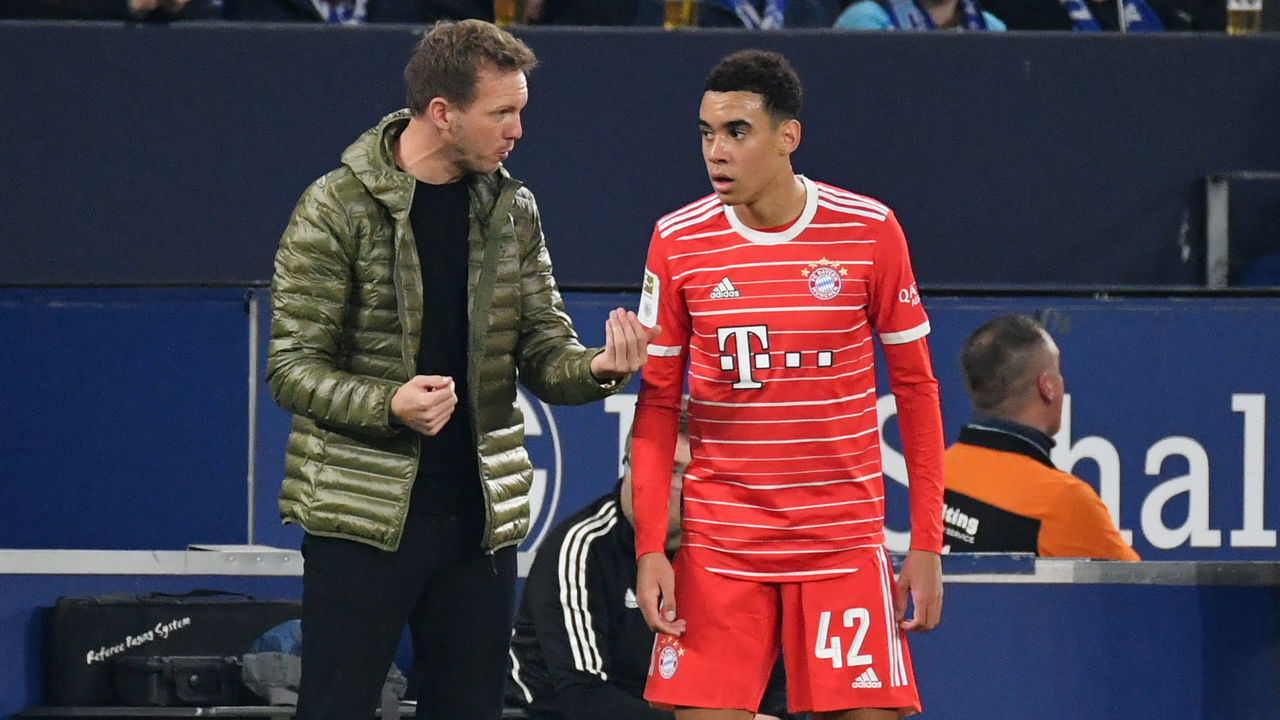 Bayern Munich's German head coach Julian Nagelsmann (L) speaks with Bayern Munich's German midfielder Jamal Musiala during the German first division Bundesliga football match between Schalke 04 v Bayern Munich in Gelsenkirchen, western Germany, on November 12, 2022. - - DFL REGULATIONS PROHIBIT ANY USE OF PHOTOGRAPHS AS IMAGE SEQUENCES AND/OR QUASI-VIDEO