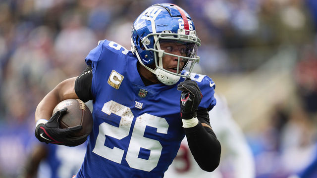 EAST RUTHERFORD, NJ - NOVEMBER 13: Saquon Barkley #26 of the New York Giants carries the ball against the Houston Texans during the first half at MetLife Stadium on November 13, 2022 in East Rutherford, New Jersey.