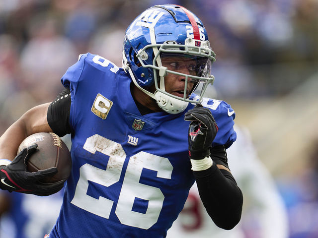 EAST RUTHERFORD, NJ - NOVEMBER 13: Saquon Barkley #26 of the New York Giants carries the ball against the Houston Texans during the first half at MetLife Stadium on November 13, 2022 in East Rutherford, New Jersey.
