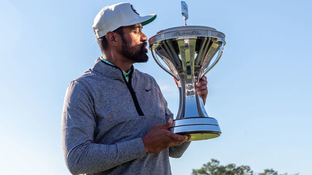 HOUSTON, TX - NOVEMBER 13: Tony Finau (USA) kisses the Cadence Bank Houston Open trophy during Final Round of the Cadence Bank Houston Open at Memorial Park Golf Course on November 13, 2022 in Houston, Texas.