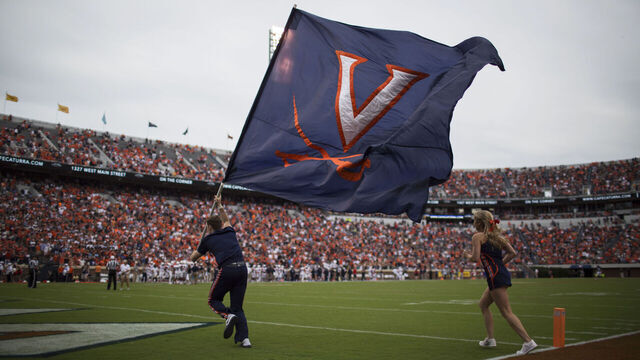 CHARLOTTESVILLE, VA - SEPTEMBER 03: Cheerleaders raise the Virginia Cavaliers flag after a UVA touchdown during a game against the Richmond Spiders at Scott Stadium on September 3, 2016 in Charlottesville, Virginia. Richmond beat Virginia 37-20 in the Virginia Cavaliers home opener.